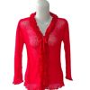Atasan rajut sheer lengan panjang merah dengan V-neck dan detail frill (kerutan) vertikal dan tali ikat di dada.